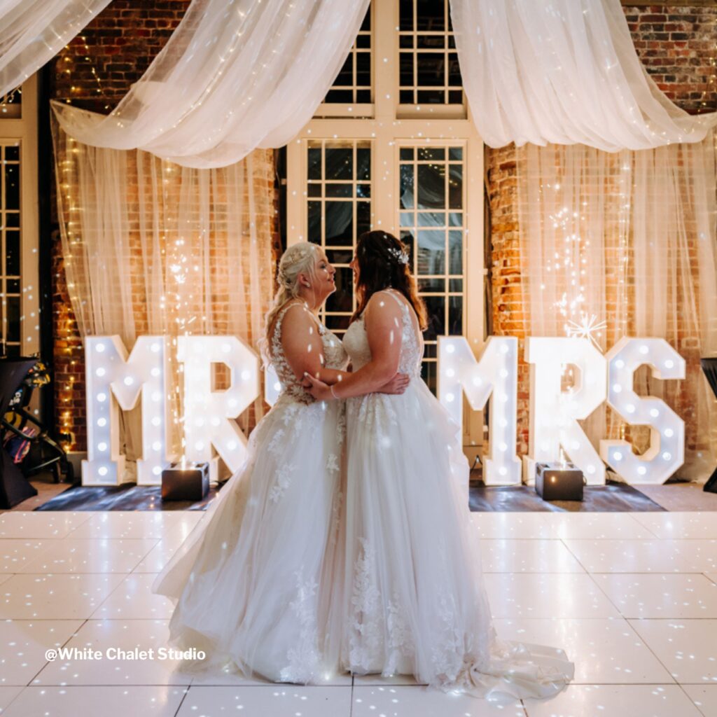 two brides dancing together